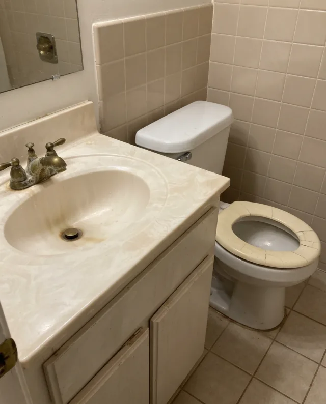 Dated bathroom with limescale-covered faucet — before fixture upgrade